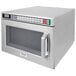 A Panasonic stainless steel commercial microwave oven with a window and digital display.