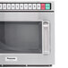 A close-up of a Panasonic stainless steel commercial microwave with a door and a window.
