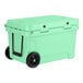 A seafoam green CaterGator outdoor cooler with black wheels.