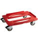 A red plastic dolly for Cambro hot boxes with black wheels.