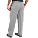 Uncommon Chef unisex houndstooth chef pants in grey and white with a person wearing them and their hands in their pockets.