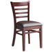 A Lancaster Table & Seating mahogany wood ladder back chair with dark brown vinyl cushion seat.