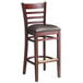 A Lancaster Table & Seating mahogany wood ladder back bar stool with a dark brown vinyl seat.