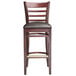 A Lancaster Table & Seating mahogany wood ladder back bar stool with dark brown vinyl seat on a white background.