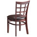 A Lancaster Table & Seating mahogany wood window back chair with dark brown vinyl seat.
