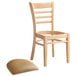 A Lancaster Table & Seating wooden restaurant chair with a light brown vinyl seat on a white background.