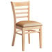 A Lancaster Table & Seating wood ladder back chair with a light brown vinyl seat.