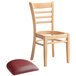 A Lancaster Table & Seating wooden ladder back chair with a detached burgundy seat cushion.