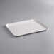 A white rectangular MFG Tray on a gray background.