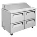 A white Turbo Air refrigerated sandwich prep table with four drawers.