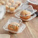A group of muffins in Choice clear plastic containers.