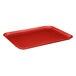 A red MFG Tray rectangular cafeteria tray on a table.
