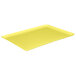 A yellow rectangular MFG Tray on a white surface.