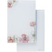 Two white rectangular Quartet glass dry erase desktop notepads with pink flowers on them.