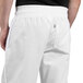 A man wearing Uncommon Chef white classic chef pants.