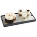 A Cal-Mil Madera cold concept base tray with a cake and jars of cream and desserts on it.