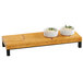 A Madera rustic pine rectangle wood riser with two bowls of food on it.