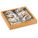 A bamboo tray with a stainless steel insert holding oysters on ice.