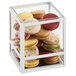 A white square presentation case with a stack of macarons inside.
