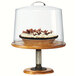 A cake on a Cal-Mil rustic pine pedestal stand with a glass cover.