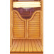 The wood surface of a Southwest themed saloon door with a mirror and bottles on it.