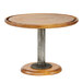 A round wooden Cal-Mil pedestal cake stand with a metal base.