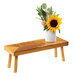 A Madera rustic pine wood riser holding a white vase with a sunflower on a wooden bench.