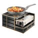 A pan with shrimp and lemons on top of a Cal-Mil black metal butane stove frame.