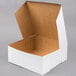 A white cardboard bakery box with an open lid.
