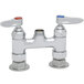A white T&S double pantry base faucet with two chrome handles.