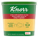 A green and yellow container of Knorr Professional Chili Con Queso Dip Mix on a counter.