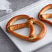 A tray with two Dutch Country Foods Bavarian-Style Soft Pretzels on it.