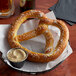 A Dutch Country Foods Bavarian-style soft pretzel with salt on a plate.