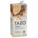A white and orange Tazo box with a white carton of Tazo Chai Tea Latte concentrate.