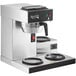 An Avantco commercial automatic coffee maker with three lower decanter warmers on a counter in a professional kitchen.