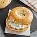 Two Original New York Style Jalapeno Bagels with cream cheese on top.
