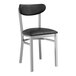 A black metal Lancaster Table & Seating Boomerang chair with black vinyl seat and back.