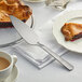 A piece of pie served on a plate with an American Metalcraft stainless steel pie server.