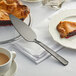 A knife and a piece of pie on a plate with the American Metalcraft hammered black vintage pie server.