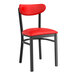 A black chair with red vinyl seat and back.