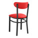 A Lancaster Table & Seating black chair with red vinyl seat and back.