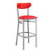 A red and silver Lancaster Table & Seating bar stool with a red vinyl seat and back.