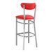 A Lancaster Table & Seating red vinyl bar stool with silver legs.