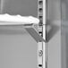 A white metal shelf for an Avantco worktop refrigerator.