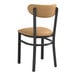 A Lancaster Table & Seating Boomerang Series Black chair with a light brown vinyl cushion on the seat and backrest.
