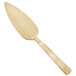 An American Metalcraft gold cake server with a long handle.