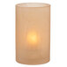 A Wysp Amber Satin Glass Cylinder Candle Holder with a lit candle on a white surface