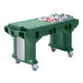 A green Cambro Versa work table with heavy duty casters holding a green plastic bin with bottles in it.
