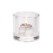 A Hollowick clear glass tealight holder with a lit candle inside.
