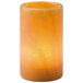 A Hollowick Onyx Cylinder Lamp with a lit candle inside.